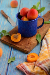 still life with apricots , blue background , matching orange and blue colors .