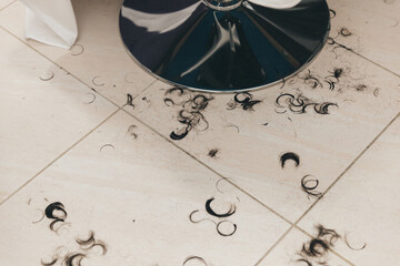cut hair on the floor in the barbershop.