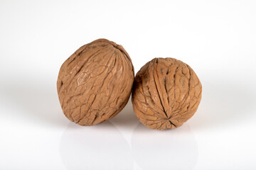 Two shelled walnuts on a white background,closeup