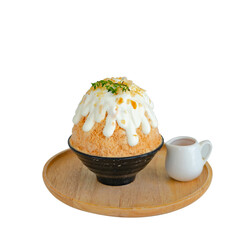 Japanese shaved ice dessert , milk tea kakigori bingsu topped with sweet whipping cream almond stick Thai tea sauce condensed milk in cafe. Traditional summer dessert menu in Japan.