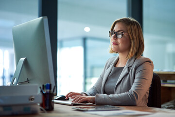 Computer, typing and business woman in office working late on project at night alone. Desktop,...