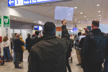 Meeting at the airport, person holding a placard card sign with welcome title text, greeting...