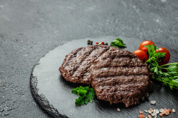 grilled hamburger patties on a dark background, banner, menu, recipe place for text, top view