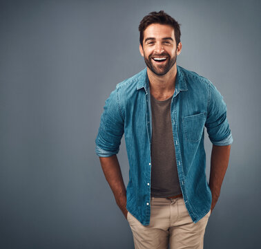 Portrait, mockup and man with a smile, fashion and confident guy against a grey studio background. Face, male person and model with happiness, casual outfit and laugh with clothes, relax and funny