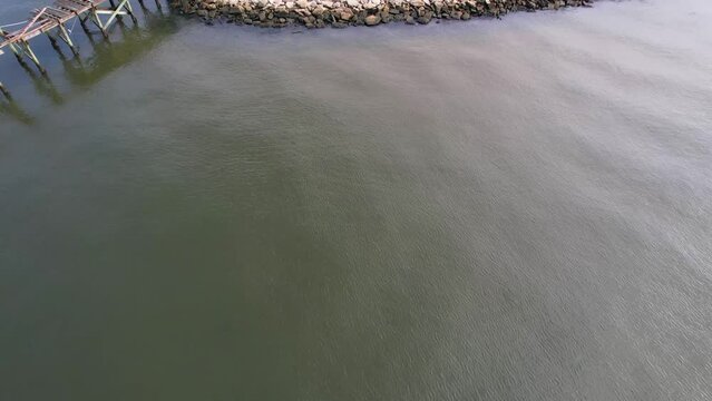 Aerial footage of fishing jumping in Lake Ponchartrain in Mandeville Louisiana.  Taken at Sunset Point fishing pier.