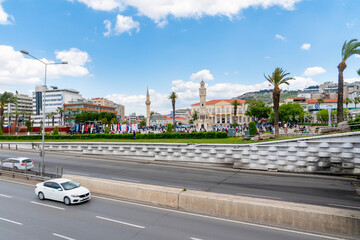 Izmir, Turkey - April 28 2023: Panoramic view of Konak Square with old clock tower, mosque and the Konak just near the highway