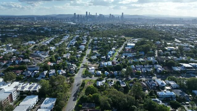 Establishing drone shot from above Morningside Brisbane, Looking over suburb towards Brisbane City. Camera pushing in towards Brisbane City skyscrapers
