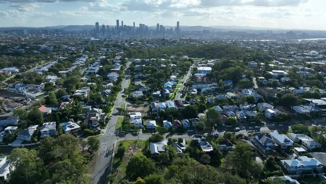 Establishing drone shot from above Morningside Brisbane, Looking over suburb towards Brisbane City. Camera ascending and pulling backwards.