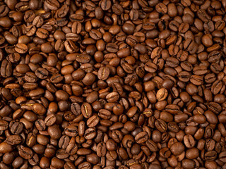 Background from roasted coffee beans. Scattered coffee beans. Coffee beans close up.