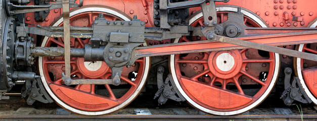 Big red wheels of a steam locomotive