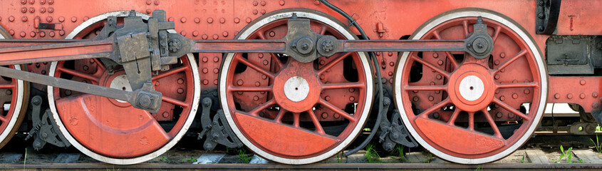 Big red wheels of a steam locomotive