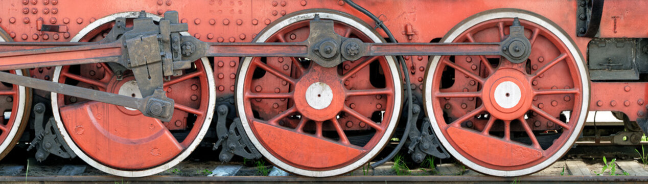 Big red wheels of a steam locomotive