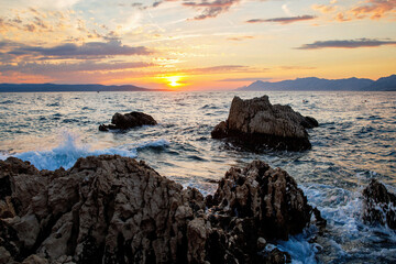Amazing beach sunset with endless horizon and incredible foamy waves.