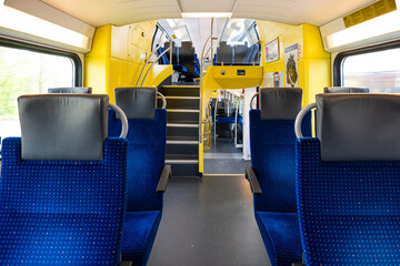 Empty seats on a passenger train in Europe. Wide-angle view, day time, no people