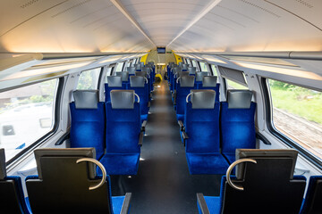 Empty seats on a passenger train in Europe. Wide-angle view, day time, no people
