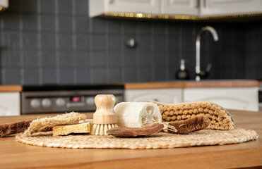 Border made of various cleaning brushes and sponges of various natural materials in home kitchen....