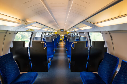 Empty seats on a passenger train in Europe. Wide-angle view, day time, no people