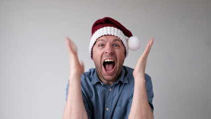 man in a New Year's hat is happy to welcome the New Year. Excited about the New Year's activities...