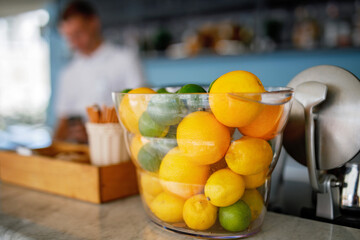 Fresh lemons and limes for preparing cocktail in a summer cafe or bar.