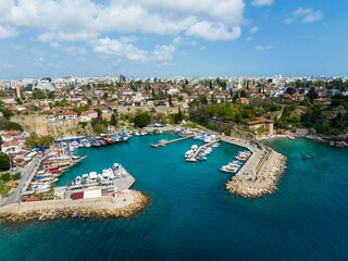 Fototapeta na wymiar This aerial photograph of Kaleiçi Marina showcases the vibrant marine activity against the backdrop of the historic cityscape.