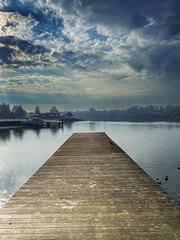 Wooden pier at the lake - Bagry Lagoon, Podgórze XIII, Kraków, Poland, still lake cloudscape sunset