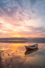 Fototapeta na wymiar beautiful landscape with a boat and the sun