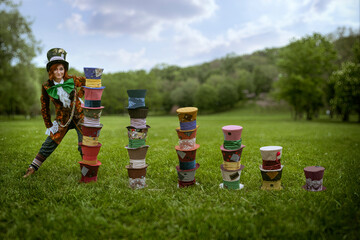 Beautiful woman as mad hatter with hats in nature