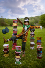 Beautiful woman as mad hatter with hats in nature - obrazy, fototapety, plakaty