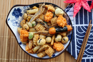 Japanese rice crackers with dry fish, seaweed and beans - Japanese finger foods called Otsumami or Arare at top view