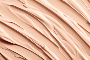 The base of the foundation is smeared as a sample background close-up. Makeup cosmetics. Concealer. Concealer texture.