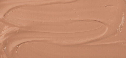 The base of the foundation is smeared as a sample background close-up. Makeup cosmetics. Concealer. Concealer texture.