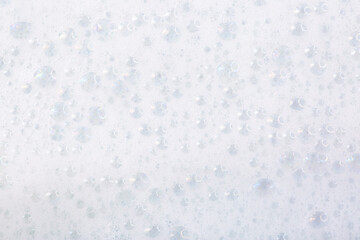 Soap foam close-up as a background. Facial cleanser foam bubbles. A foam party.