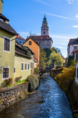 Small canal ,colorful historical buildings, castle tower, Cesky Krumlov.