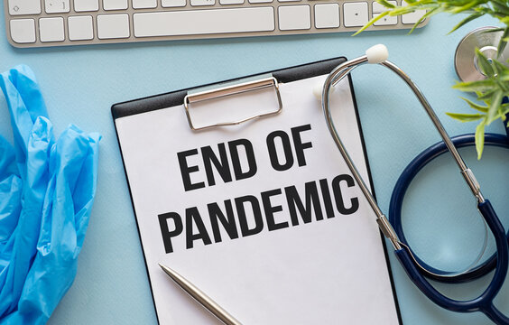 The quarantine is over. hospital medical cards, doctor's stethoscope and inscription on paper tablet End Of Pandemic. End of pandemic concept.