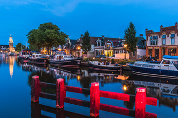 View of the illuminated historical part of the city of Lemmer in Friesland, Netherlands after sunset