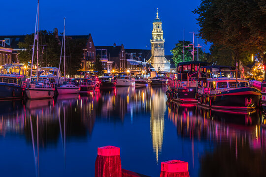 View of the illuminated historical part of the city of Lemmer in Friesland, Netherlands after sunset