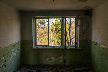 Fototapeta na wymiar Abandoned house and a ruined house with a beautiful view outside the window