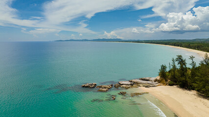 Wide sandy beach with ocean surf and waves. Borneo, Malaysia. Tindakon Dazang Beach.