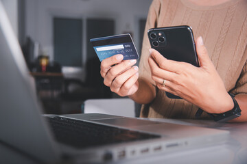 Female register via credit cards on mobile phone make digital payment security online, Business woman hands holding credit card and smartphone to pay product at home, Internet online shopping concept
