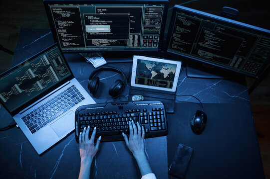 Close up top view of female hacker hands, typing on keyboard