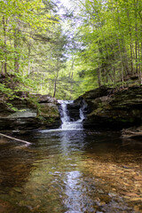 Naklejka na ściany i meble Portrait of Tranquility: A Vertical Shot of a Petite Pennsylvania Waterfall