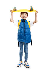 Carefree blonde boy holding yellow longboard on the head over white background.