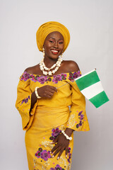 Portrait of happy Nigerian woman waving the national flag 