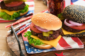 4th of July American Independence Day traditional picnic food. American Burger and cocktail, American flags and symbols of USA Patriotic picnic holiday on white wooden background. Top view