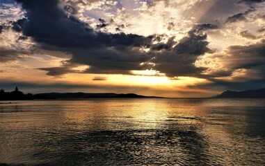 Sunset above the sea with dramatic clods