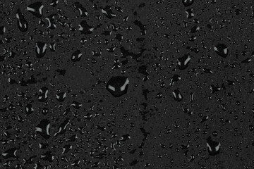 Water drops on dark stone
