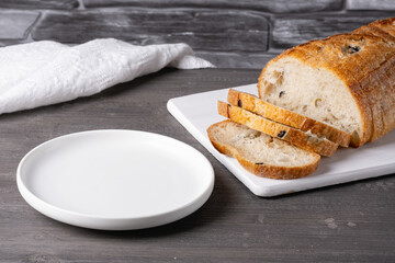 Empty plate and bread on a gray background. Empty copy space