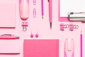 Pink stationery set on light pink background. Seamless pattern, top view. Back to school background. Creative office desktop.
