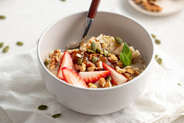 Portion of healthy oatmeal porridge with strawberries and banana