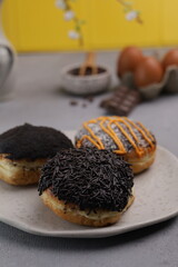 Donuts  with chocolate toppings on wooden board